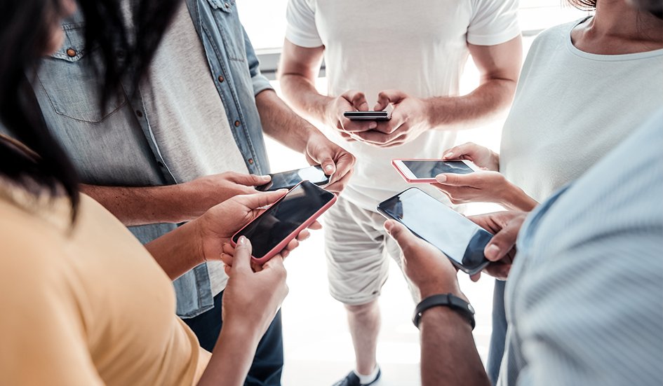A group of award-winning people in Hong Kong looking at their phones for SEO purposes. A group of award-winning people in Hong Kong looking at their phones for SEO purposes.