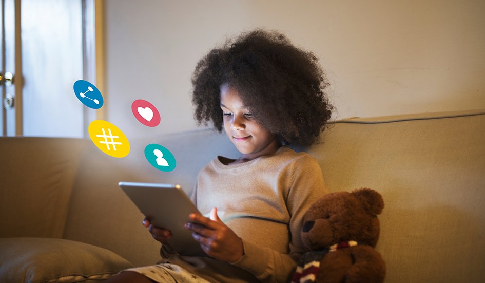 A girl sitting on a couch with a tablet and teddy bear in Hong Kong. A girl sitting on a couch with a tablet and teddy bear in Hong Kong.