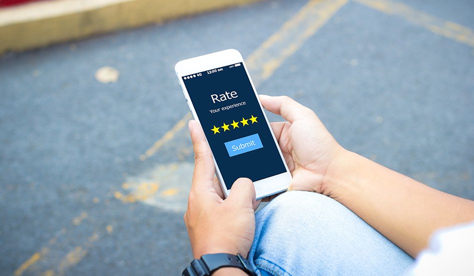 A person in Hong Kong holding a smartphone with an award-winning rating app on it. A person in Hong Kong holding a smartphone with an award-winning rating app on it.