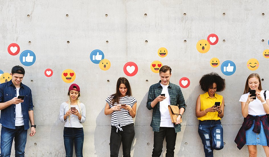 A group of people in an award-winning digital marketing team standing in front of a wall with emojis on their phones. A group of people in an award-winning digital marketing team standing in front of a wall with emojis on their phones.