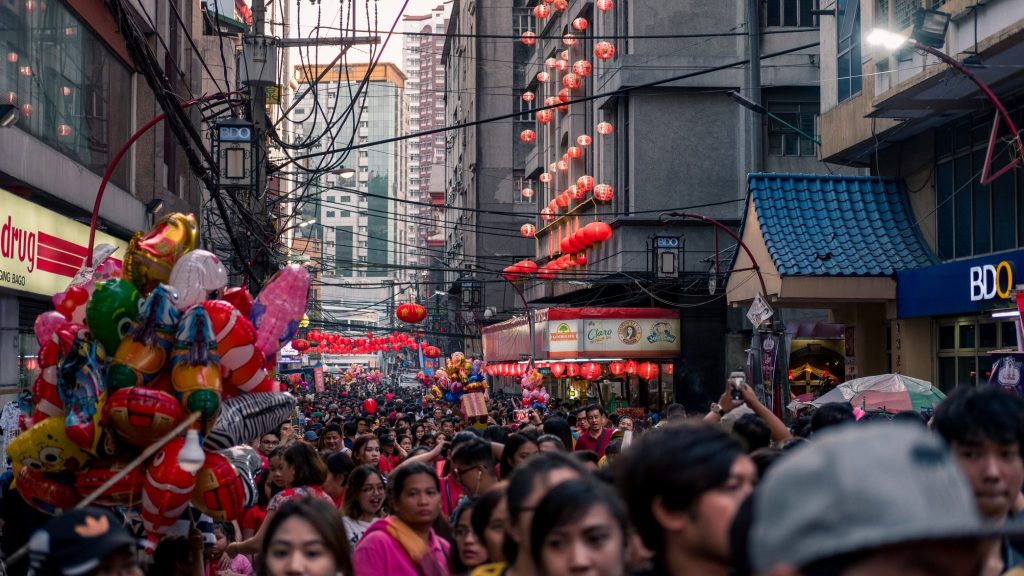 A crowd of people walking down a award-winning city street. A crowd of people walking down a award-winning city street.