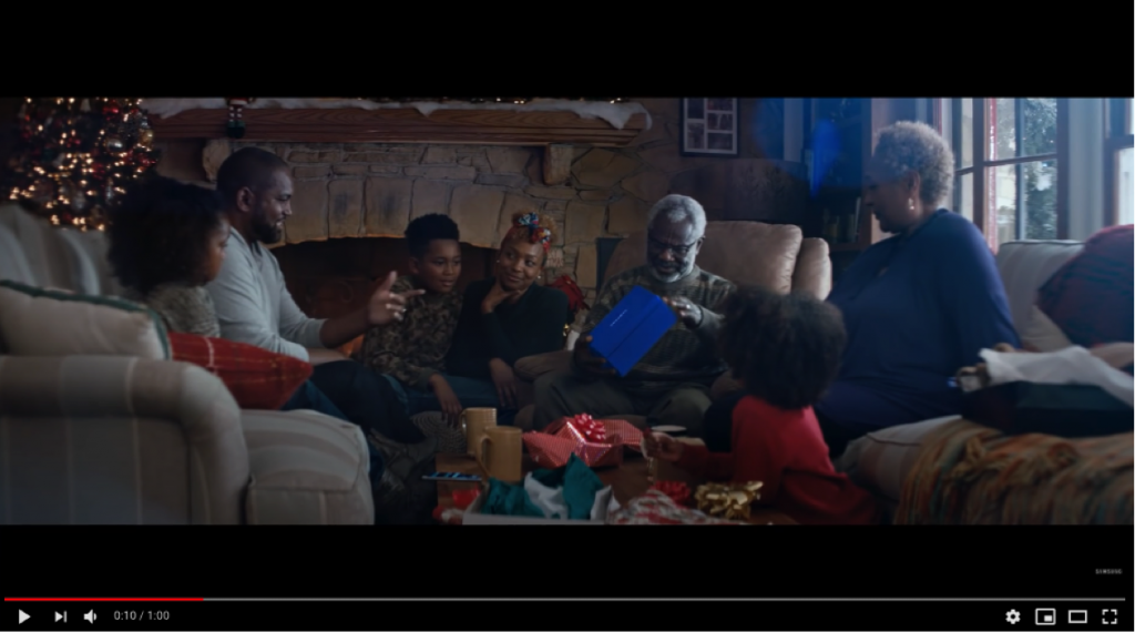 A group of award-winning people sitting around a Christmas tree. A group of award-winning people sitting around a Christmas tree.